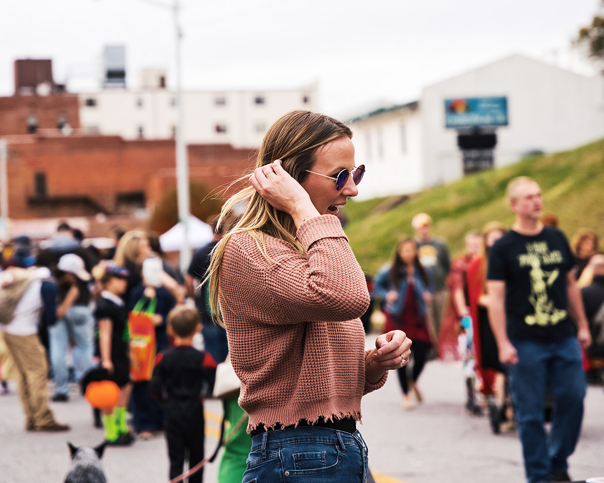 A woman moving through a busy outdoor festival