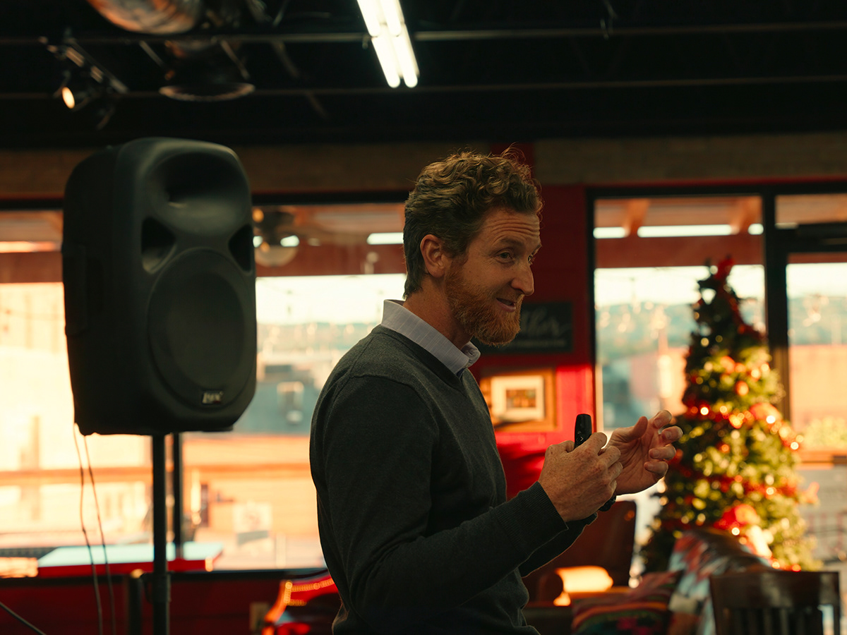 A speaker addressing an indoor community gathering